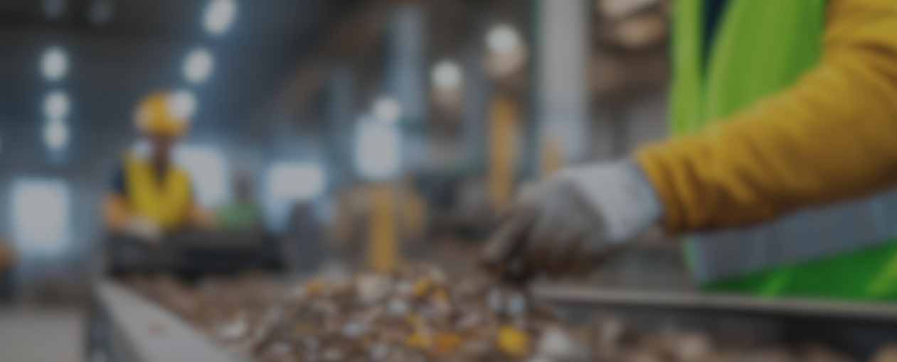 a hand out of focus picks from the recycling material line